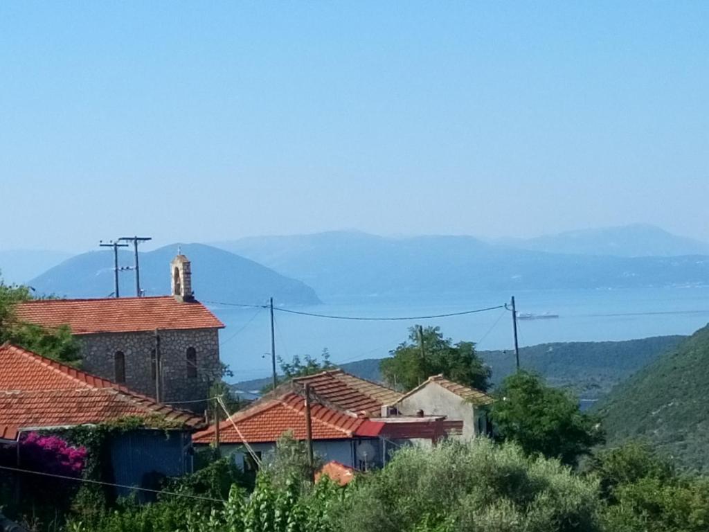 a group of houses with mountains in the background at Manto Apartments Lefkada in Évyiros