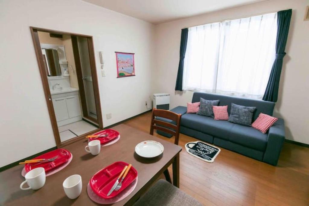 a living room with a couch and a table at Dream Misono - Vacation STAY 14777 in Sapporo