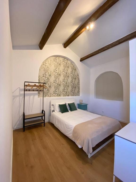 ein Schlafzimmer mit einem Bett in einem weißen Zimmer in der Unterkunft Casa do Calvário in Évora