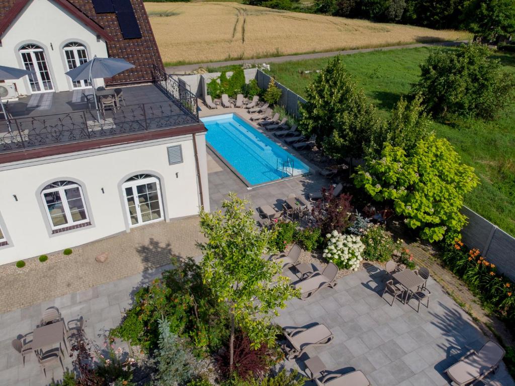 an aerial view of a house with a swimming pool at Jarzębinowy Resort & SPA in Braniewo