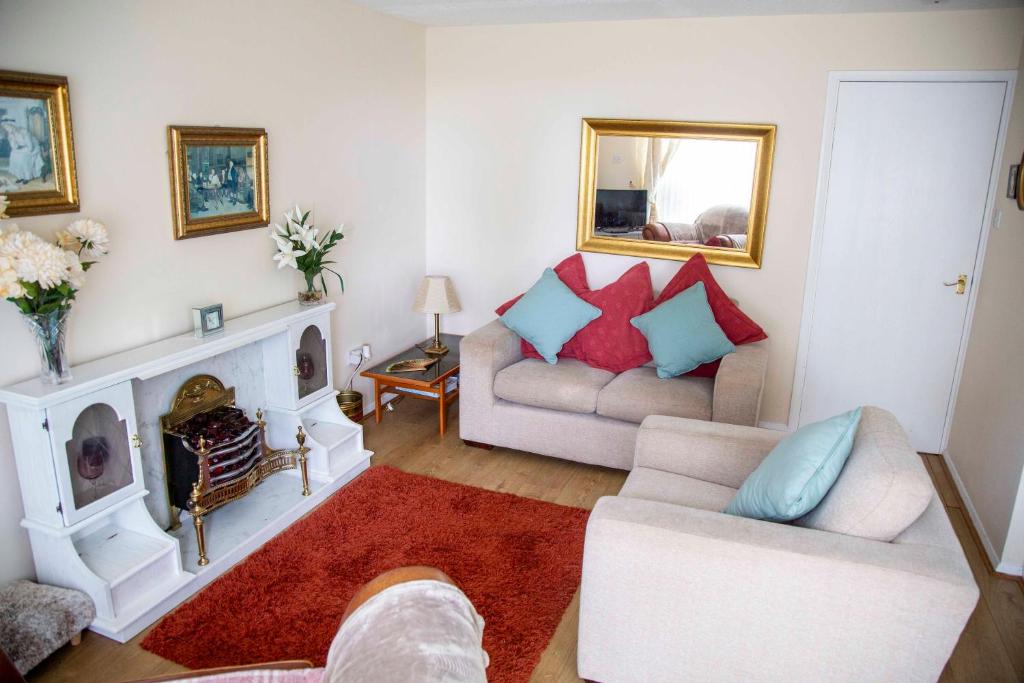 a living room with a couch and a fireplace at St Margaret's Bay Holiday Let in St Margarets at Cliff