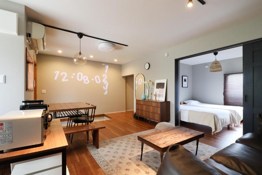 a living room with a bed and a table at HAKATA TERRACE -Toki- - Vacation STAY 14934 in Fukuoka
