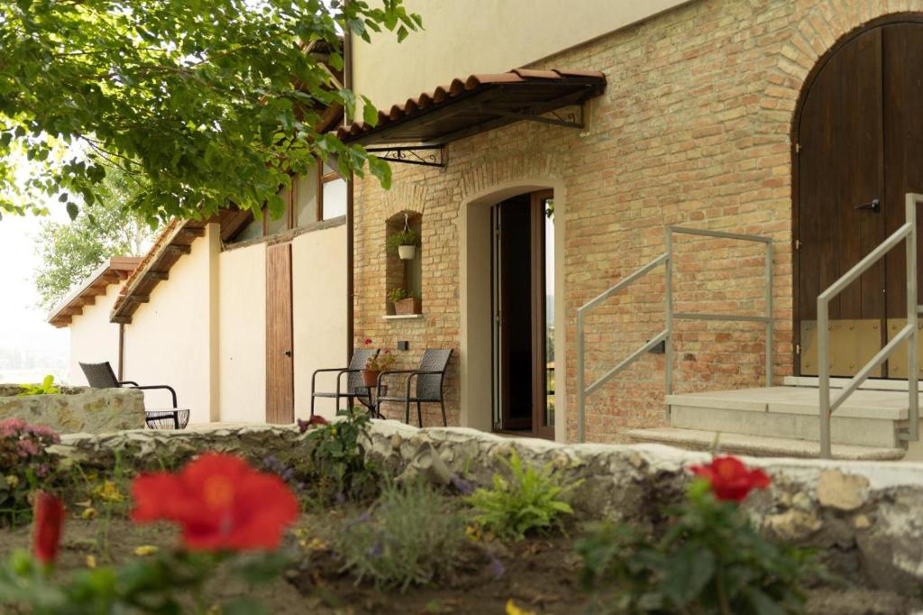 a brick house with a porch and a brick wall at Tenuta I Gelsi in Benevento
