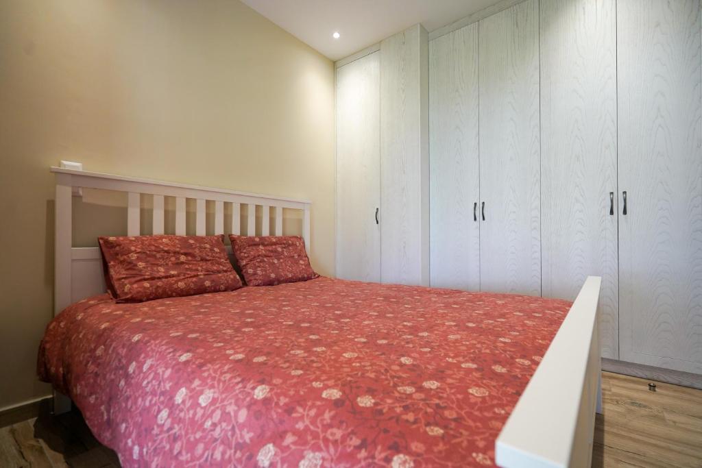 a bedroom with a bed and white cabinets at Palaiomylos Kos by Ktima Sfakia in Kos Town