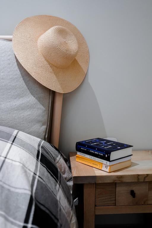 a hat sitting on top of a table with books at Palaiomylos Kos by Ktima Sfakia in Kos