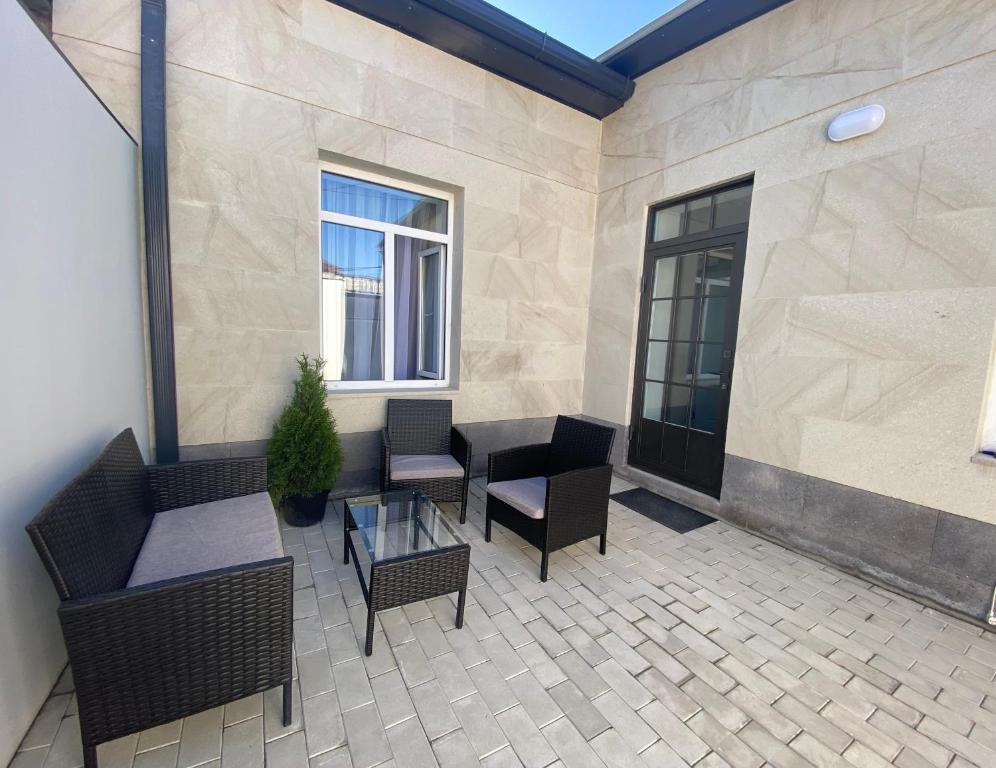 a patio with chairs and tables and a window at Your Sweet Home Gyumri in Gyumri