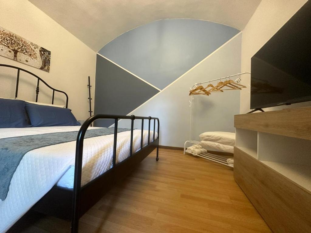 a bedroom with a bed in a room with a ceiling at Greta's Home a 2 minuti dal lago in Arona