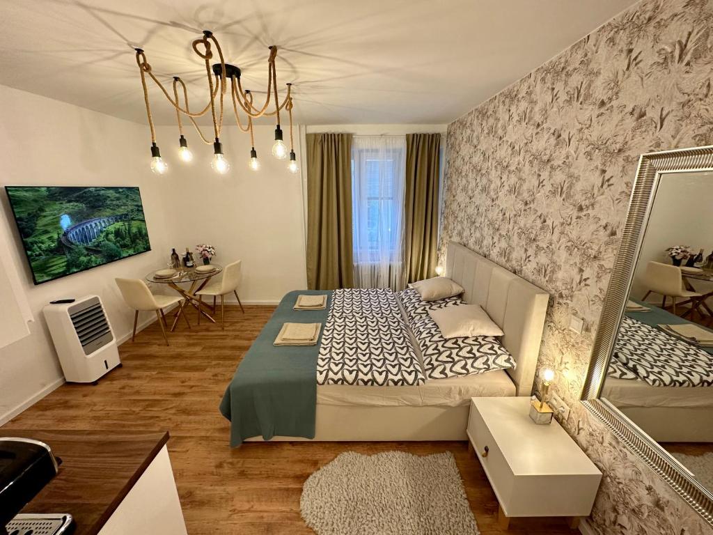 a bedroom with a bed and a table and a mirror at CASTLE HILL apt in Old Town of Bratislava with free parking in Bratislava