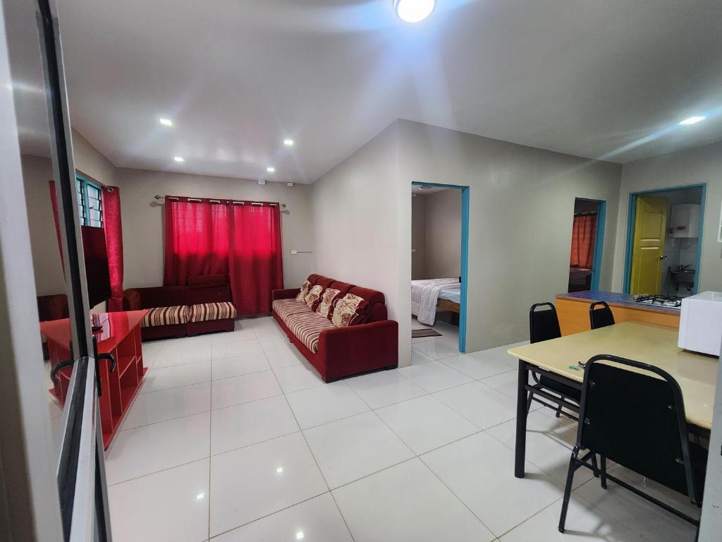 a living room with a couch and a table at Home Away from Home in Suva