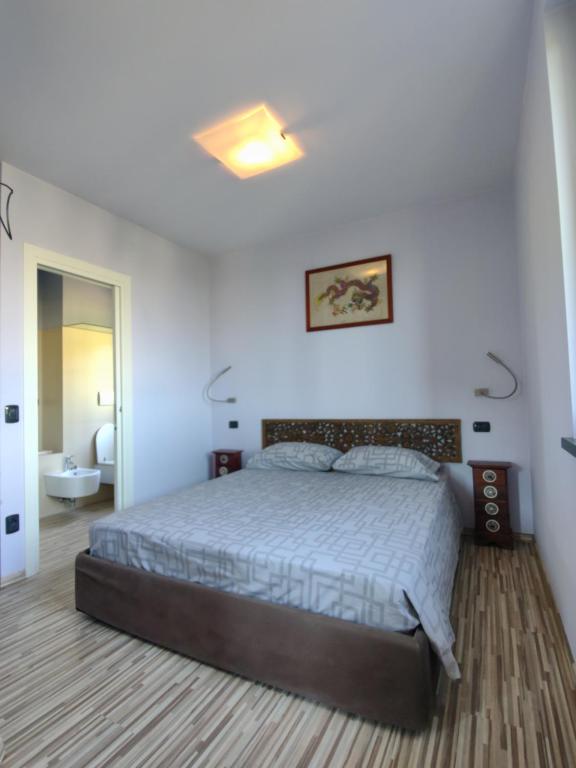 a bedroom with a large bed and a bathroom at Aminta Apartment in Valtesse