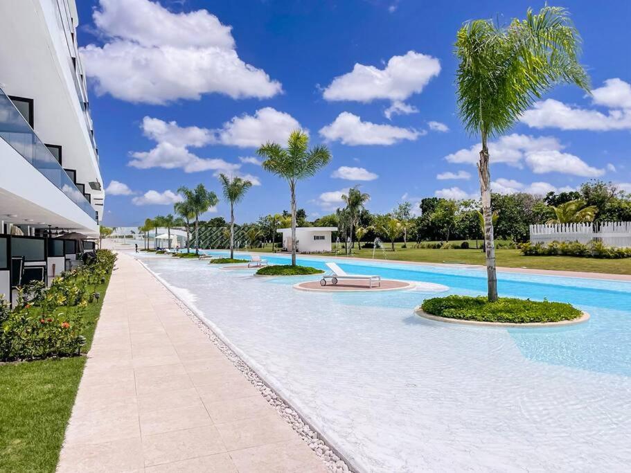 プンタ・カナにあるLuxury Apartment at Cana Rock Star Punta Cana DRのヤシの木が並ぶ大型スイミングプール