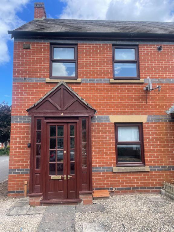 a red brick building with a wooden door at 2 bed house, walking distance Shrewsbury centre in Shrewsbury
