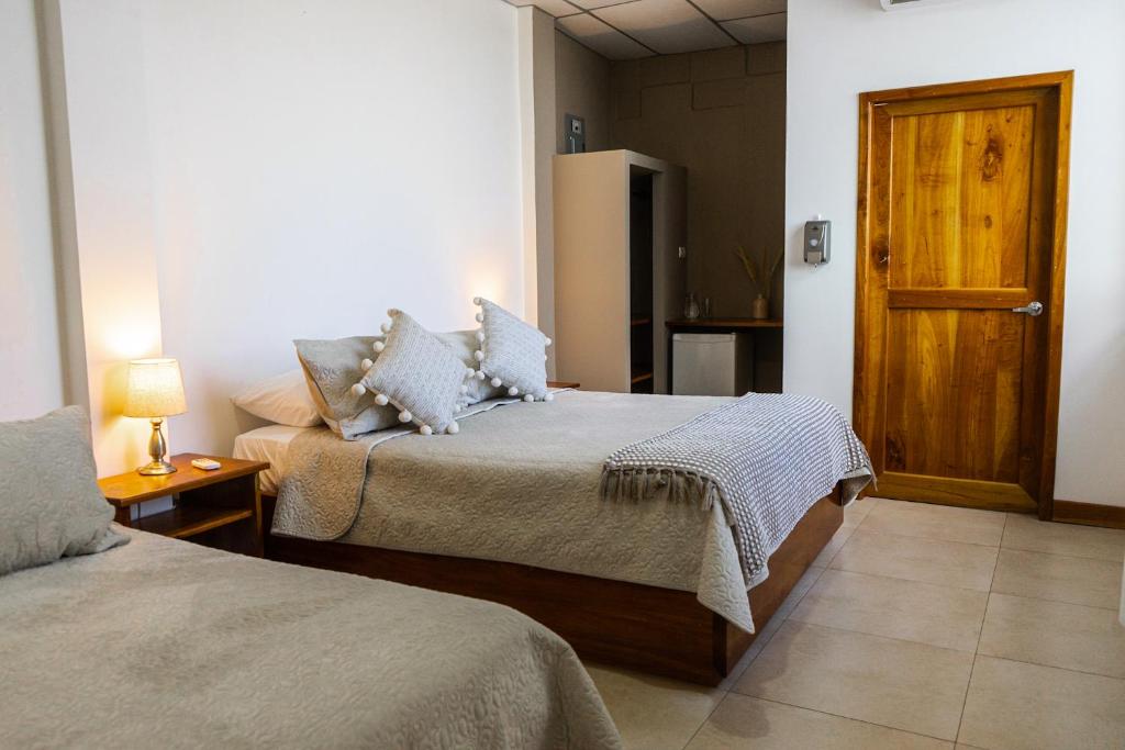 Postel nebo postele na pokoji v ubytování HOTEL AYRE By Baltra