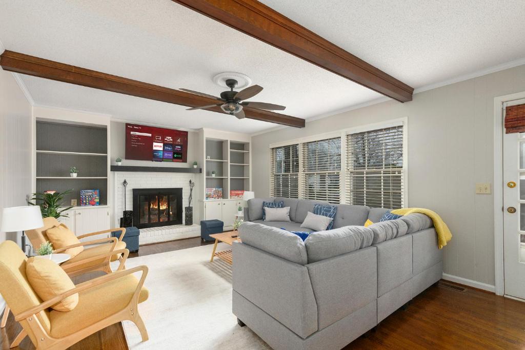 a living room with a couch and a fireplace at Cozy & Relaxing Home, Hot Tub, Fire Pit, Deck in Greensboro