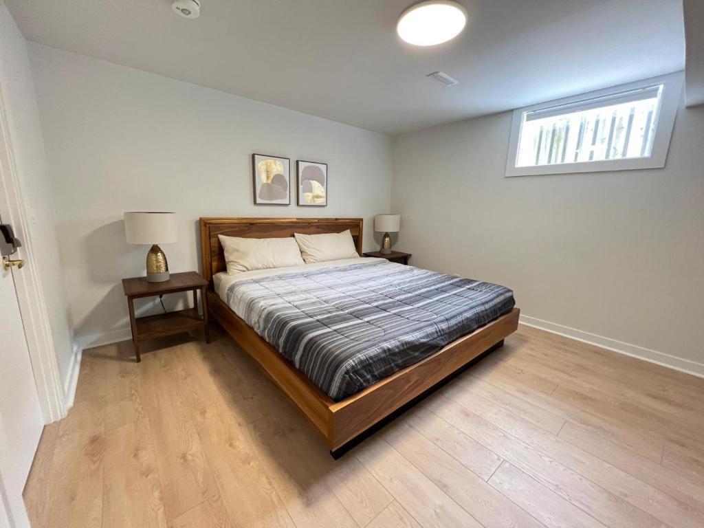 a bedroom with a bed and a window in it at Letitia Heights !A Spacious and Quiet Private Bedroom with Shared Bathroom in Barrie
