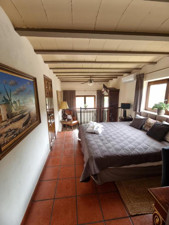 a bedroom with a bed and a painting on the wall at Masia Cal Lloa in Albinyana