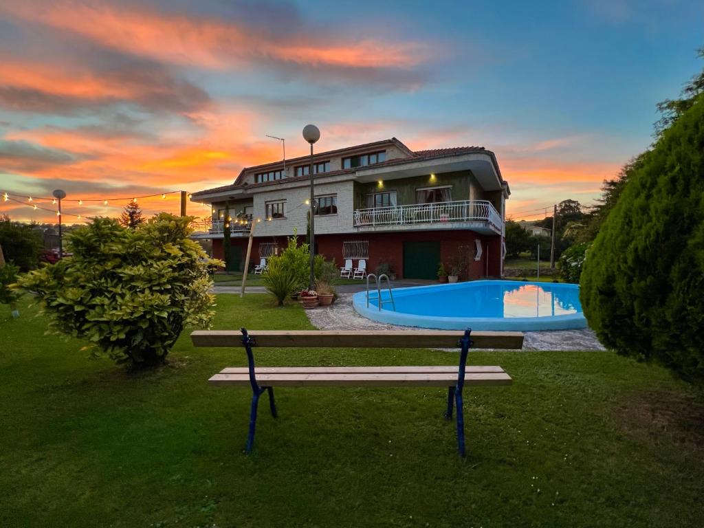 a house with a picnic table in front of a house at Camino del Soplao -zona Santillana del Mar- in Reocín