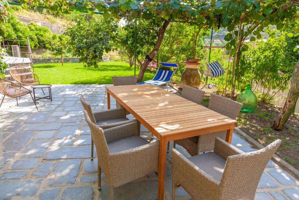 a wooden table and chairs on a patio at La Casa dei Glicini in Levanto