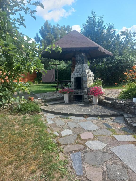 un patio de piedra con chimenea de piedra en U Ani, en Debrzno
