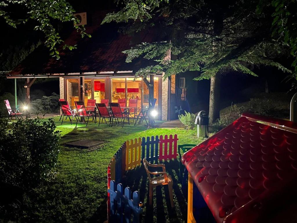 Best of Ilidza and Rakovica holiday HOME في سراييفو: منزل مع مقعد في الفناء في الليل