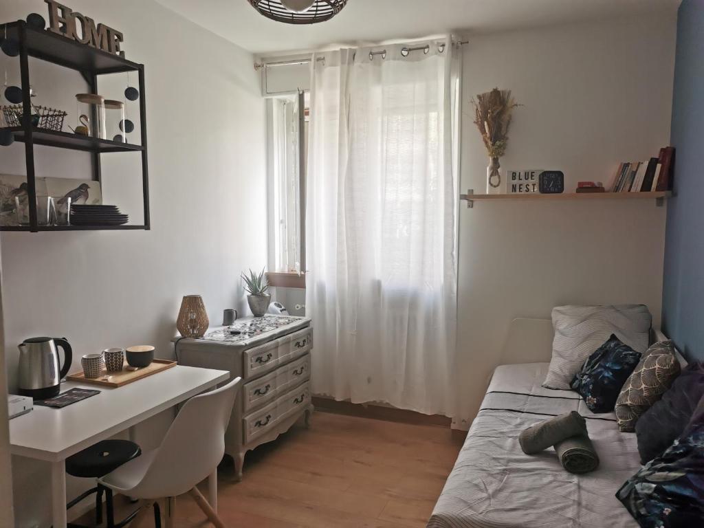 une petite pièce avec un bureau et un lit et une table et un bureau dans l'établissement Studio Blue Nest l Cosy I Wifi Fibre I, à Grenoble