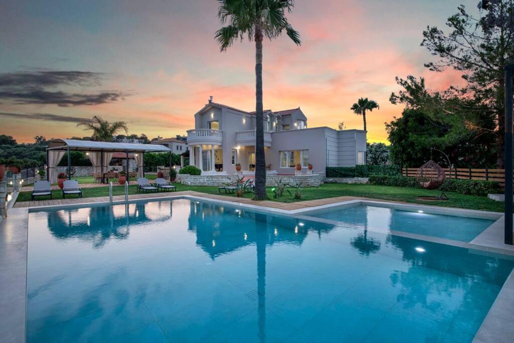 a large swimming pool in front of a house at Villa Damant in Pithárion