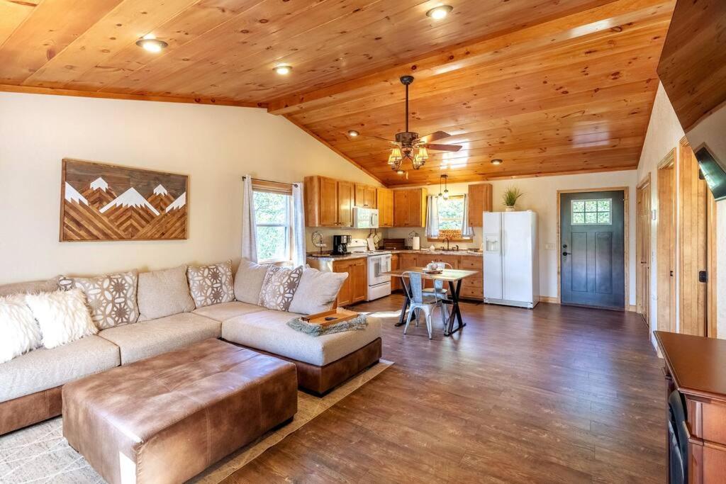 a living room with a couch and a kitchen at *New Owner Special* Cozy Cabin with mountain views in Robbinsville
