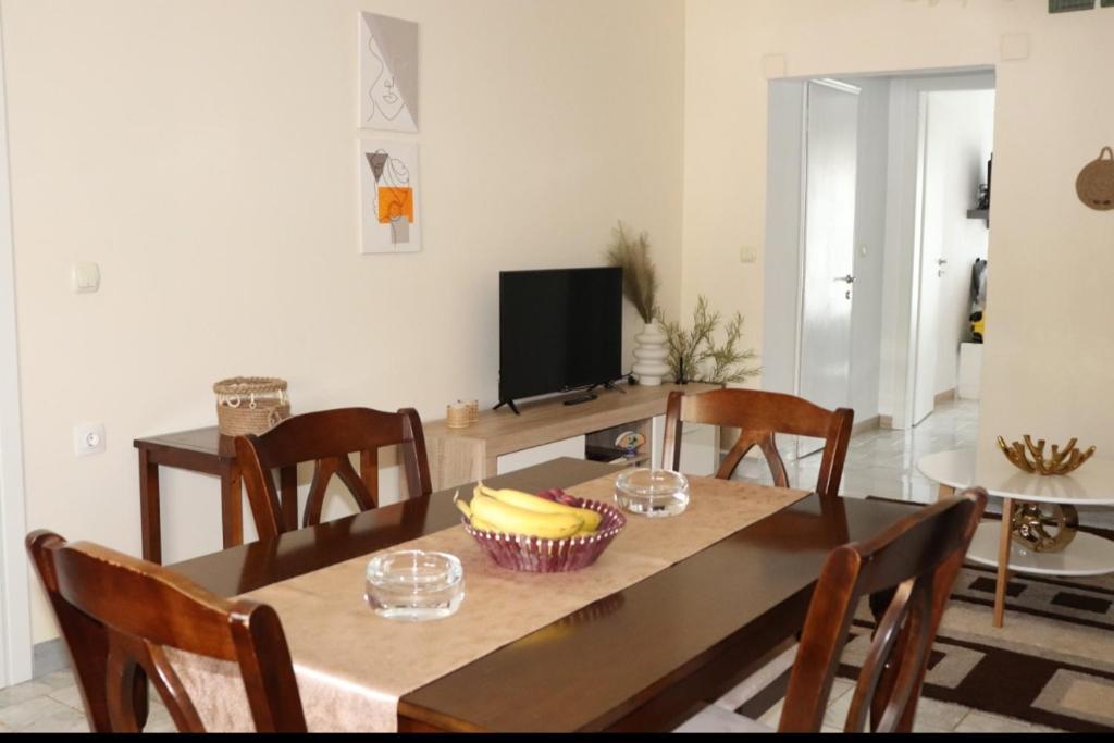 a dining room with a table with a bowl of bananas on it at Fiosal Apartments 1 in Skiathos