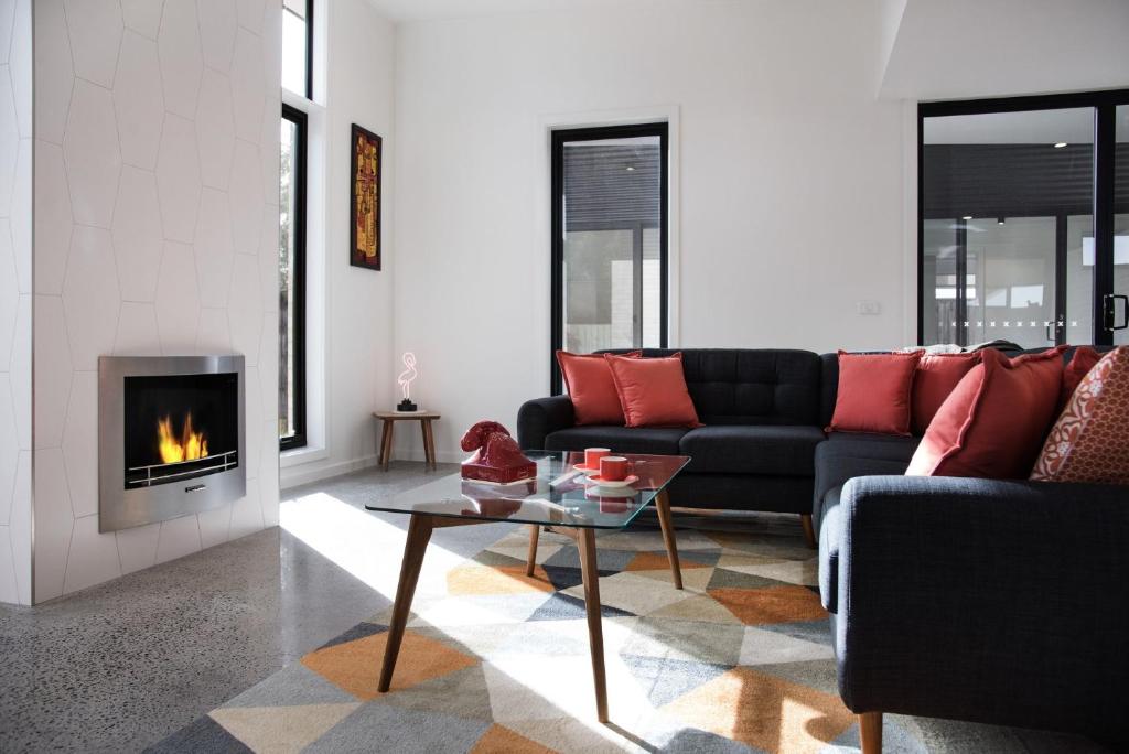 a living room with a couch and a fireplace at Arenas North - 2 bedroom dog friendly home in Daylesford