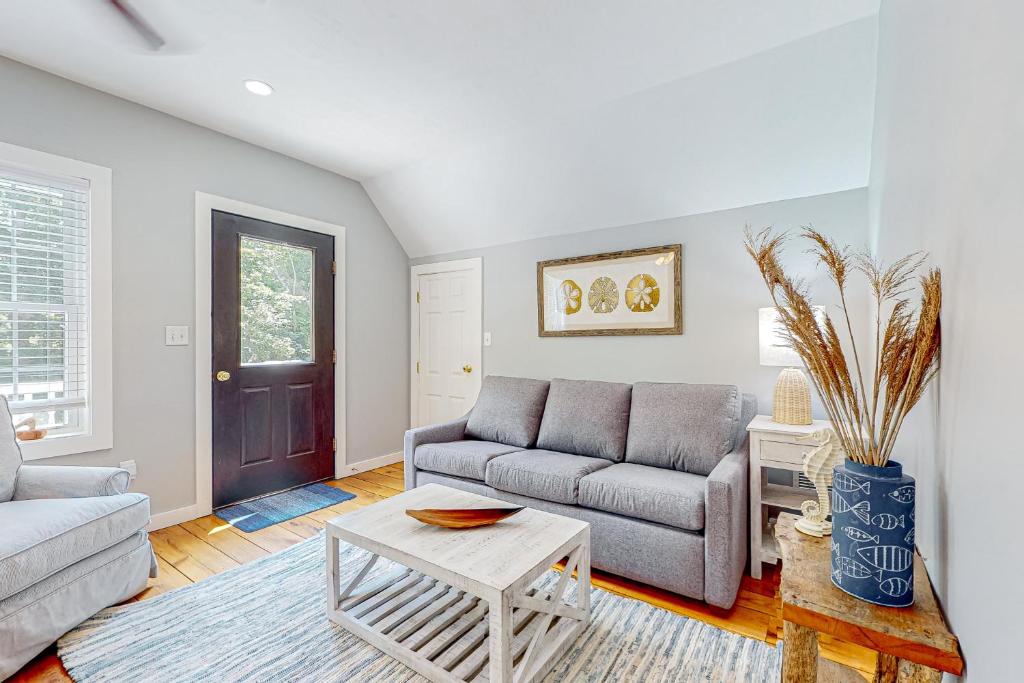a living room with a couch and a table at Island Time in Vineyard Haven