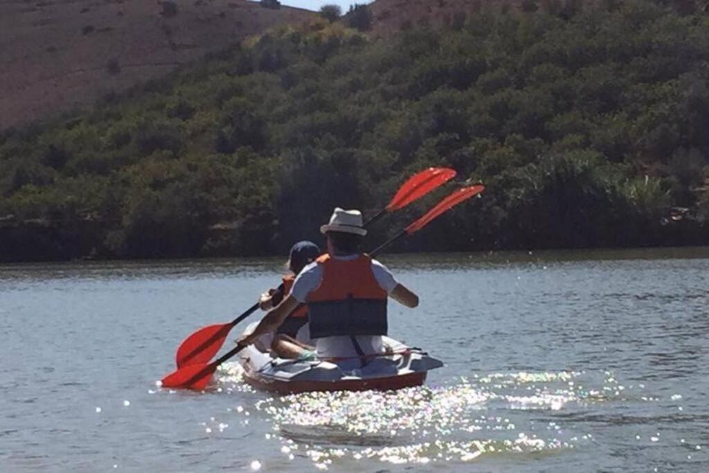 two people in a paddle boat on a lake at Lake House Boulaouane in El Jadida