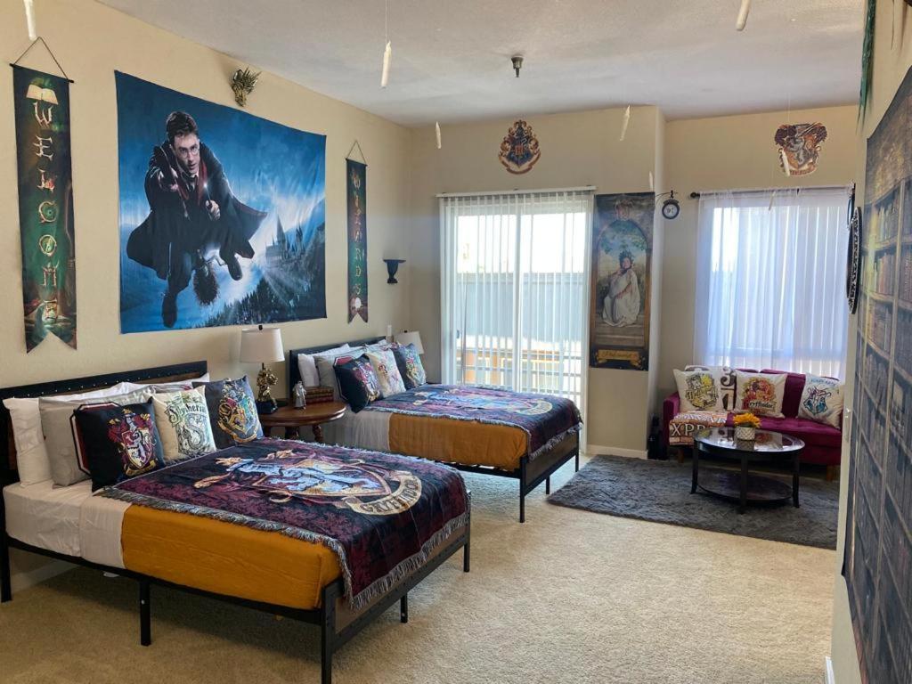 a bedroom with two beds and a large painting on the wall at Mario & Harry Potter Loft Universal Studios 10min loft apartment in Los Angeles