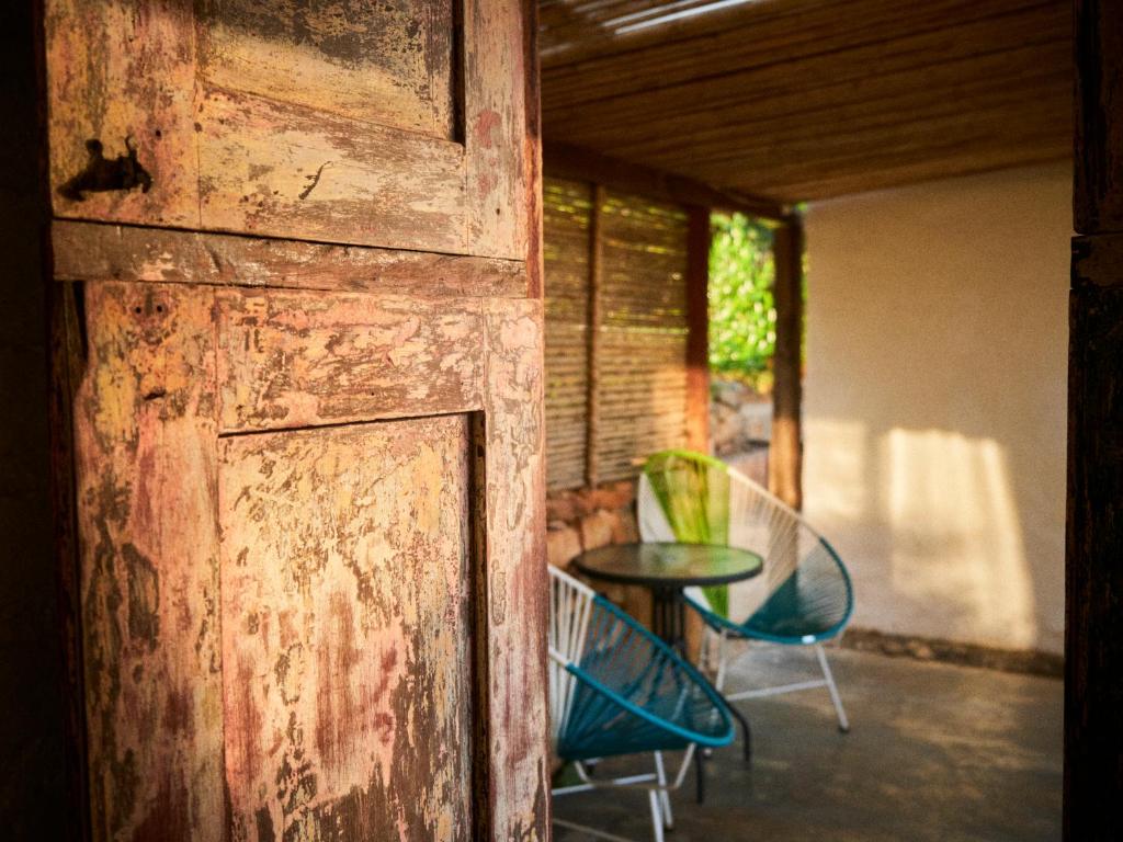 uma porta de madeira aberta com uma mesa e cadeiras em Hostal Juan Palitos em Los Santos