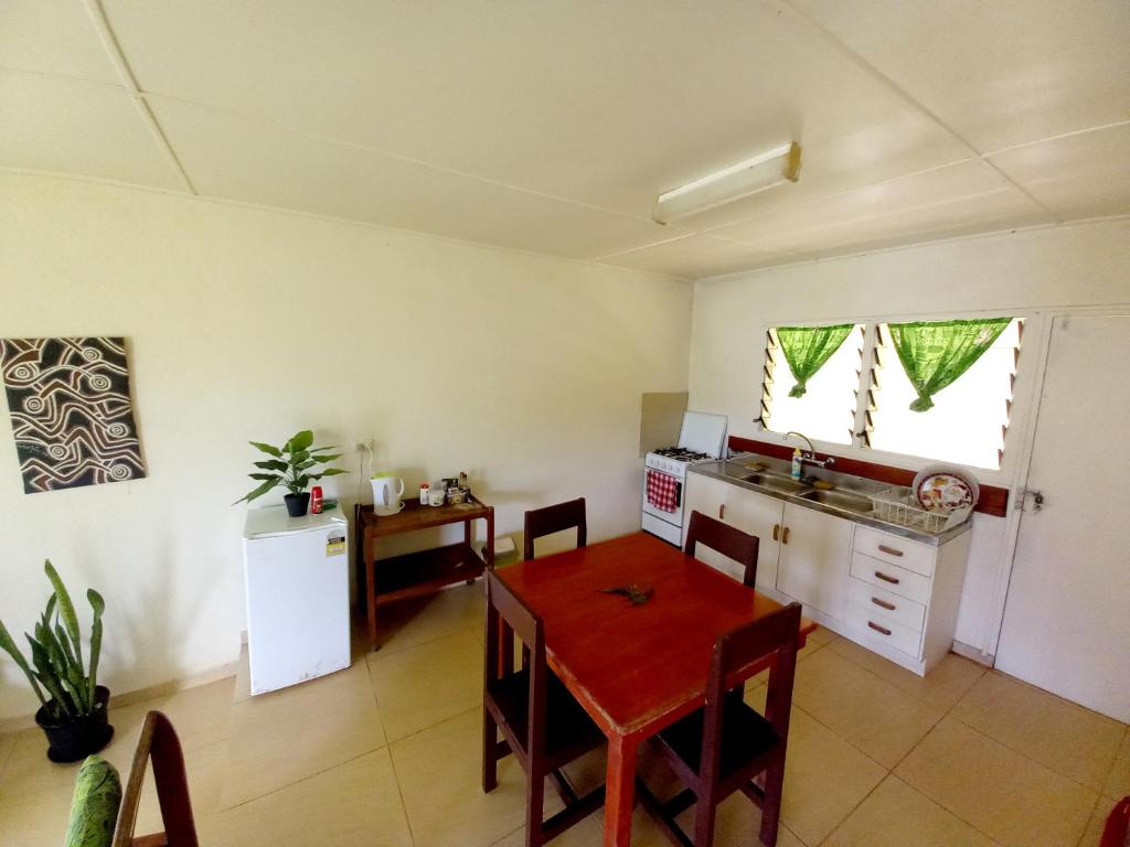 a kitchen and dining room with a table at Philomena's Lodge in Douane