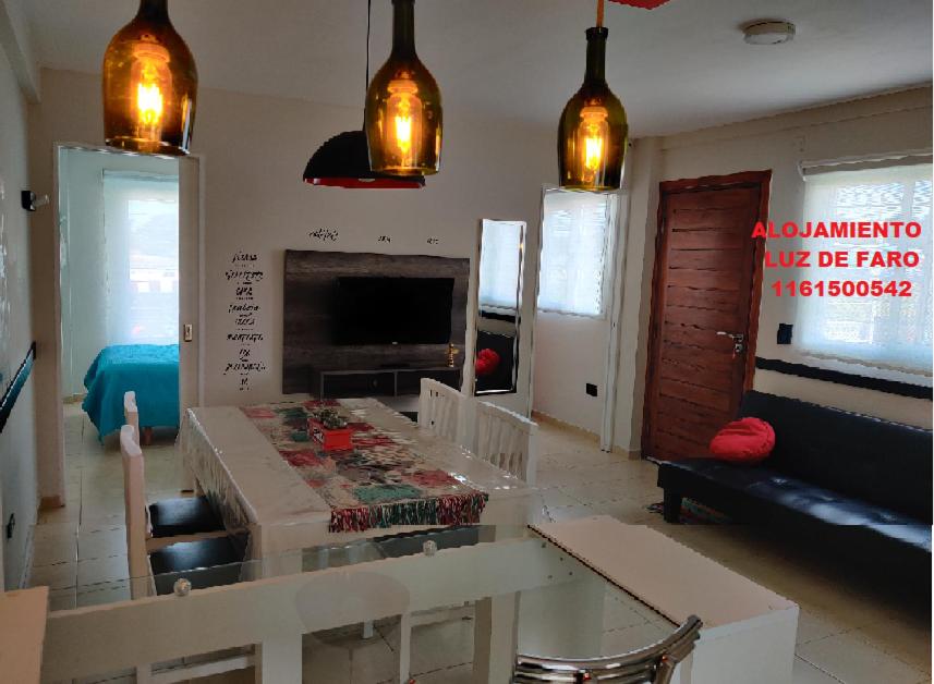 a living room with a table and a fireplace at Luz de Faro, frente a las playas mas lindas! in Mar del Plata