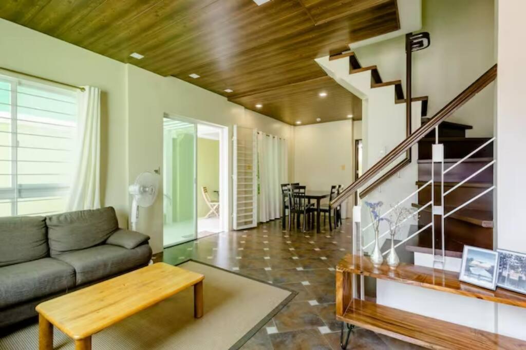 a living room with a couch and a staircase at Private Townhouse (Serenia Homestay) in San Juan