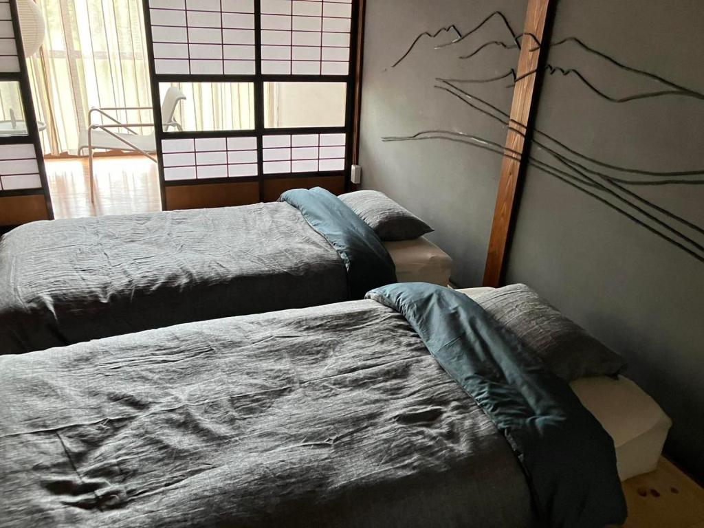 Postel nebo postele na pokoji v ubytování 町宿ORANCHI