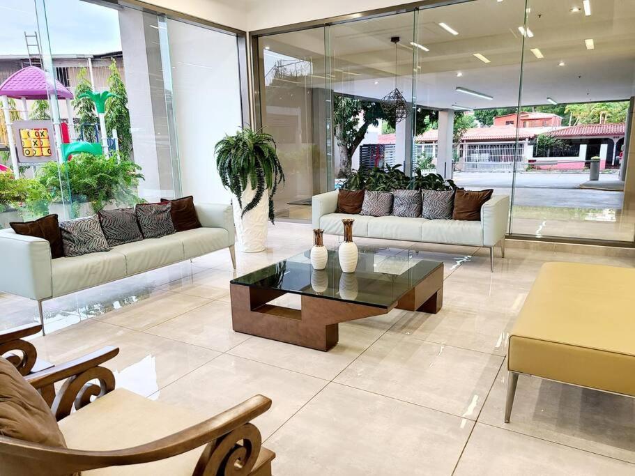 a living room with couches and a coffee table at Amazing Apt. Close to the City in Panama City