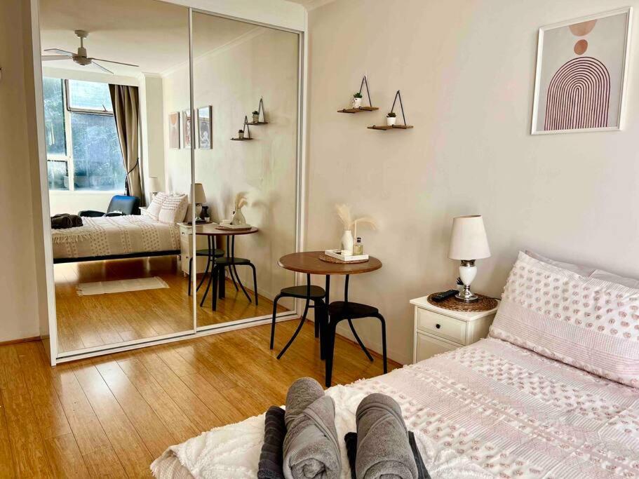 a bedroom with a bed and a mirror at Studio in Darling Point in Sydney