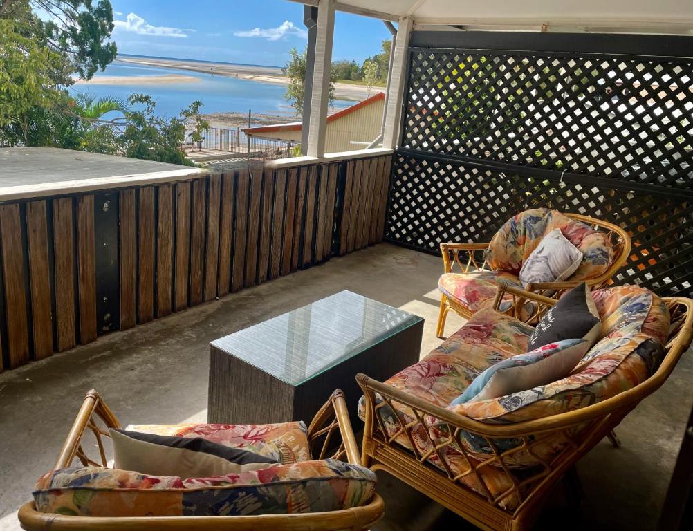 a patio with two chairs and a table on a balcony at Goody's Guest House in Toogoom