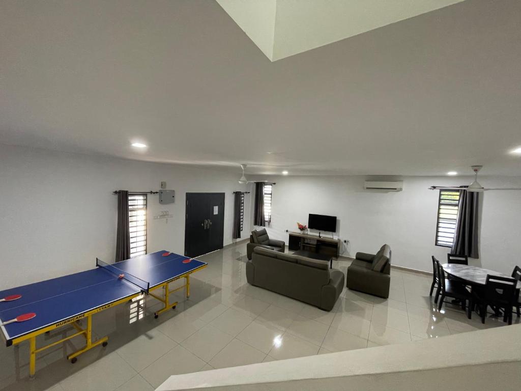 a living room with a ping pong table in it at homestay port dickson - elaine in Port Dickson