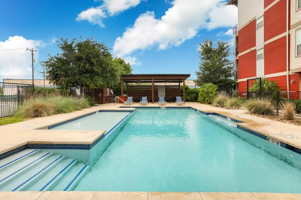 a swimming pool in front of a building at Historic Apartment Downtown SA in San Antonio