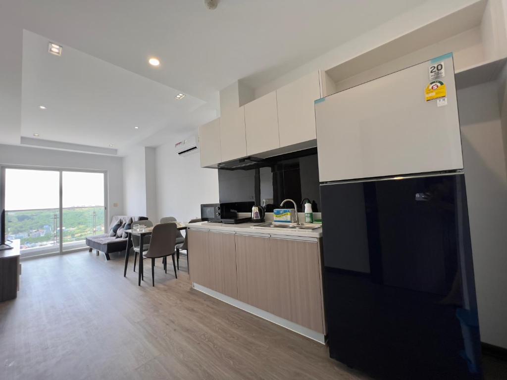 a kitchen with a black refrigerator and a dining room at Sihanouk City View Condominium in Sihanoukville