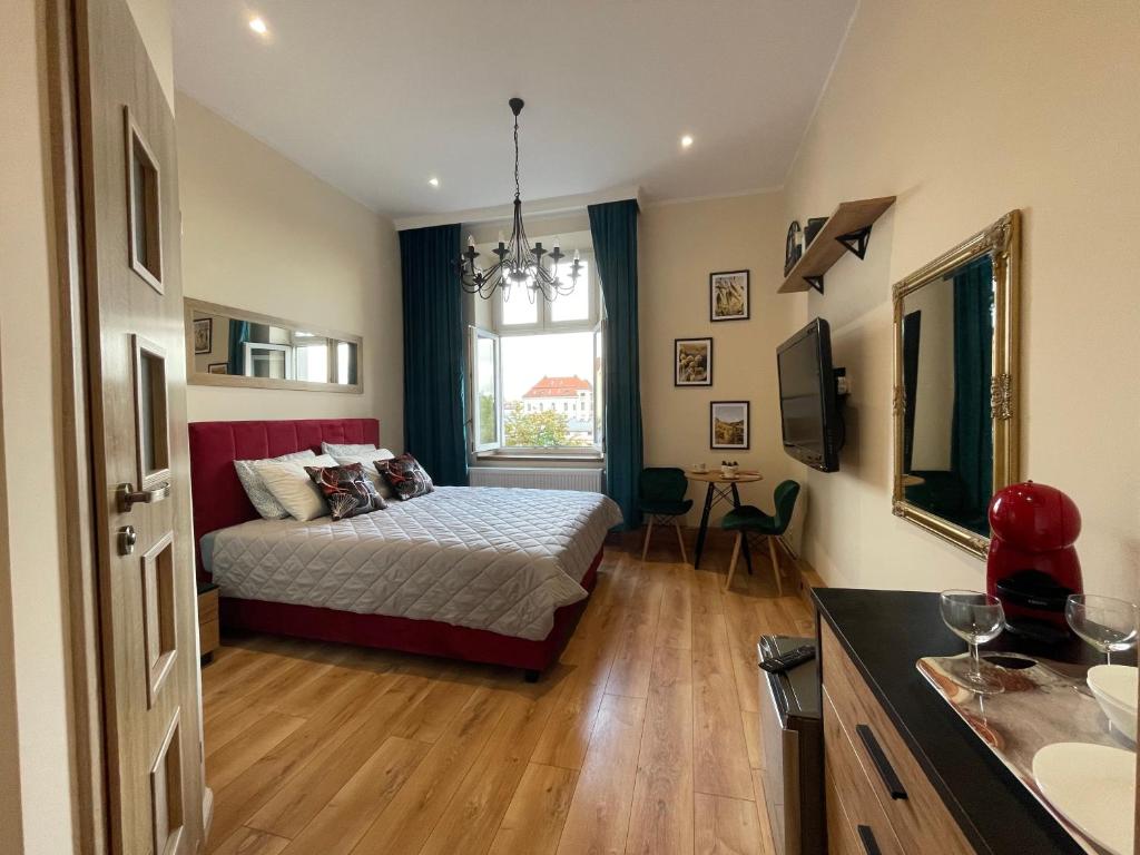 a bedroom with a bed and a window at Aparthotel Cracow in Kraków