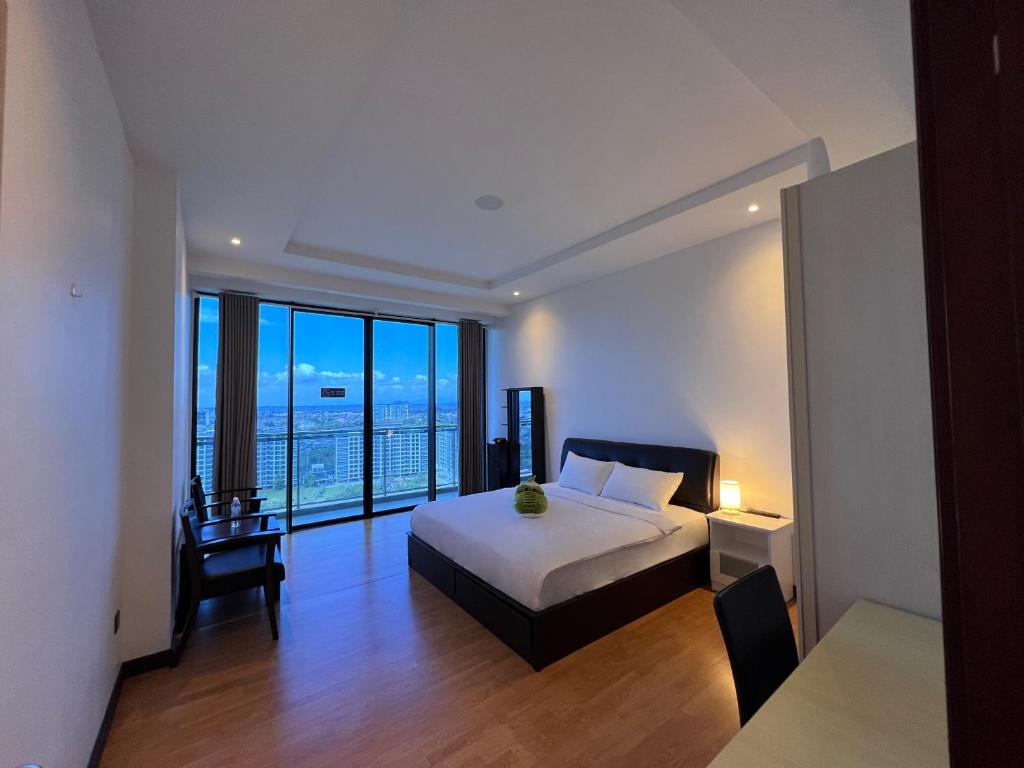 um quarto com uma cama e uma secretária com uma janela em Super comfy 1800sqft Condo in Imperial Suites Boulevard Mall em Kuching