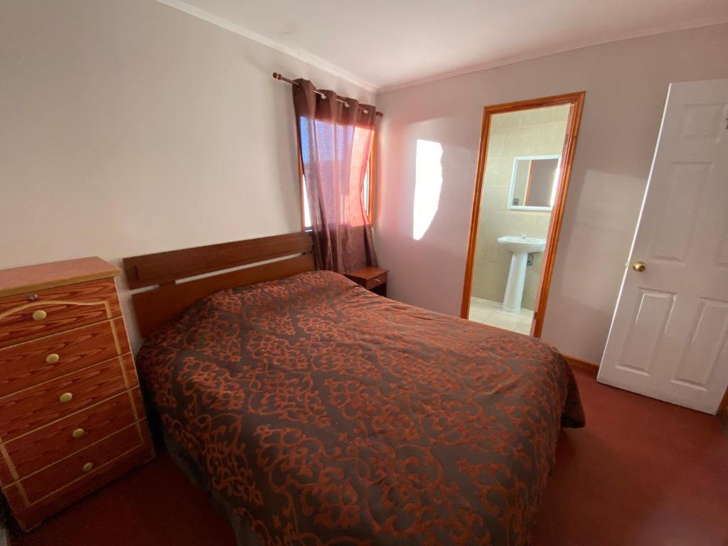 a bedroom with a bed and a dresser and a mirror at Hostal AGUSTÍN II in Cartagena