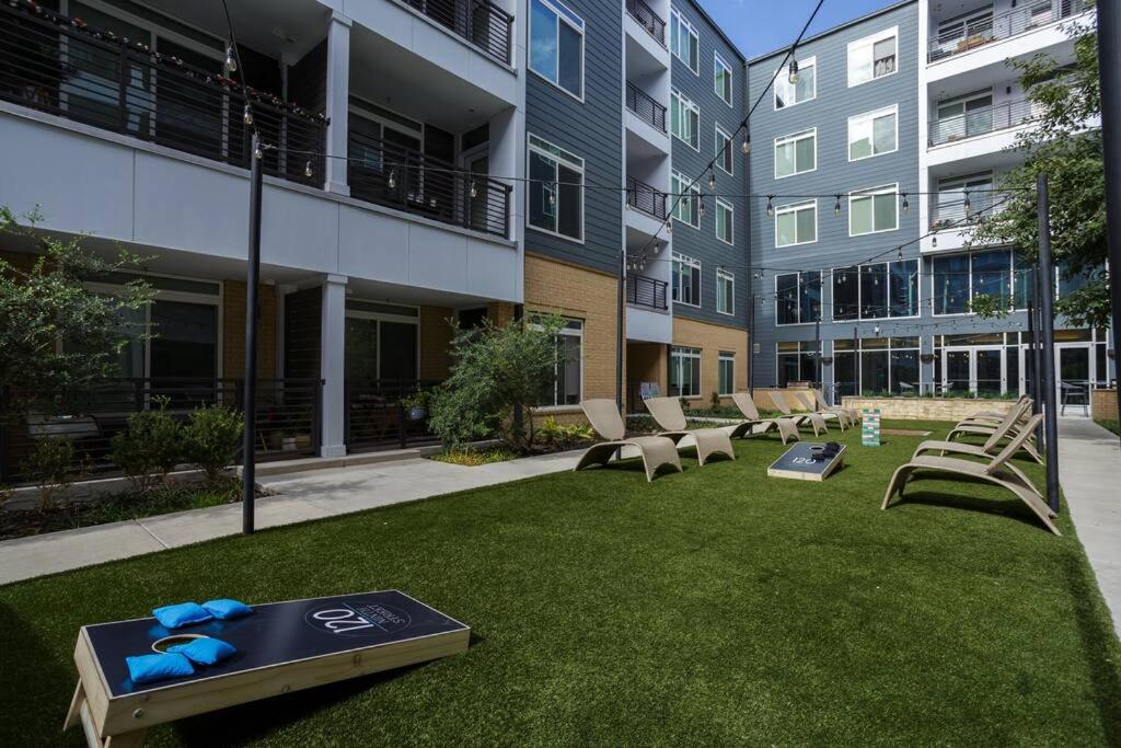 a lawn with chairs and a table in front of a building at Upscale Apartment on RiverWalk in San Antonio