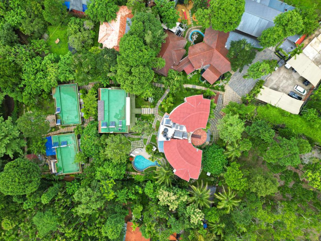 an overhead view of a park with a pool and trees at Kuruva Island Resort And Spa - By KABINI BREEZE, Wayanad in Mananthavady