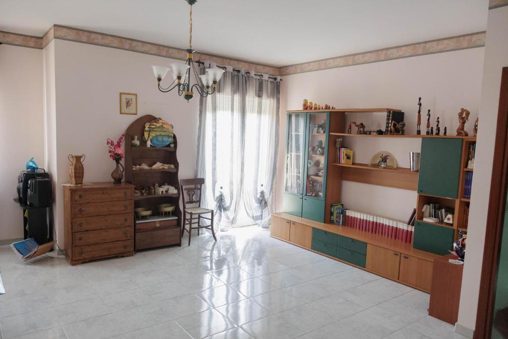 a living room filled with furniture and a large window at Perle Rare di Sicilia in Sortino