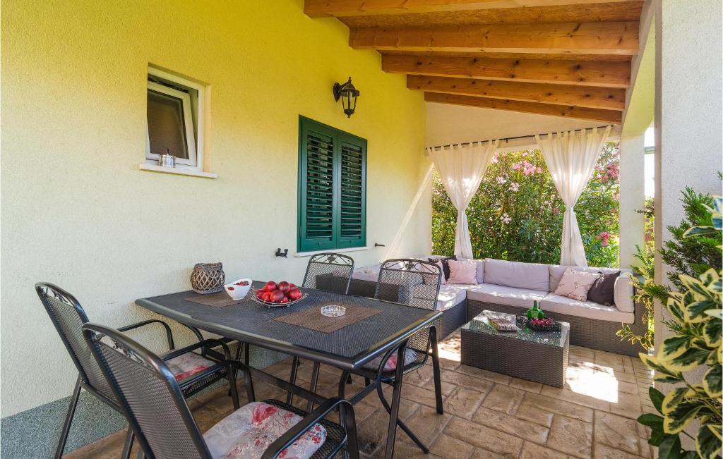 a patio with a table and chairs and a couch at Amazing Home In Split With Wifi in Split